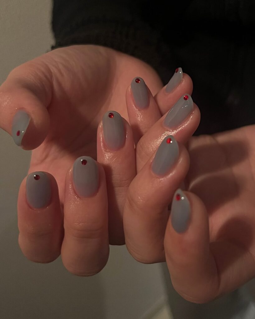 Muted Lavender-Gray Almond Nails with Red Gem Accents for Subtle Sophistication
