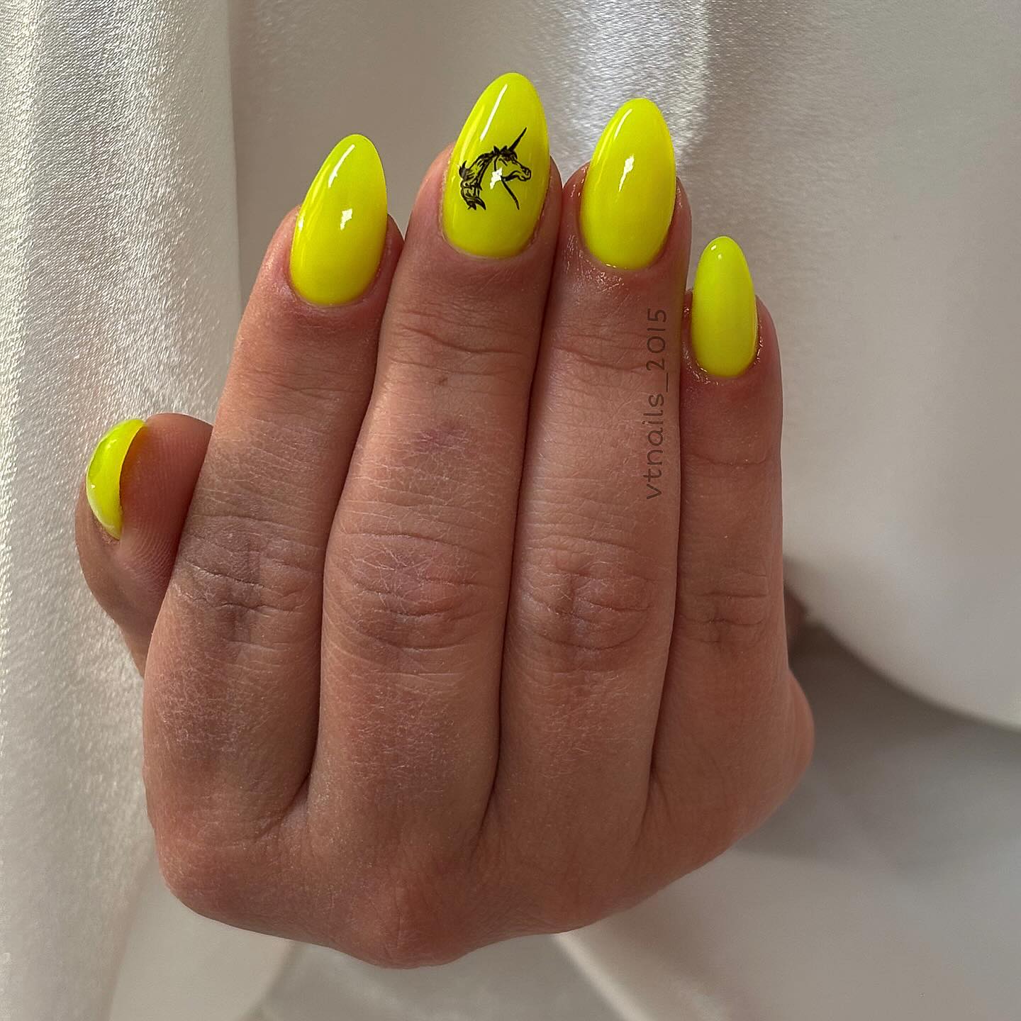 Neon Yellow Almond Nails with Black Unicorn Art for Bold Nail Ideas