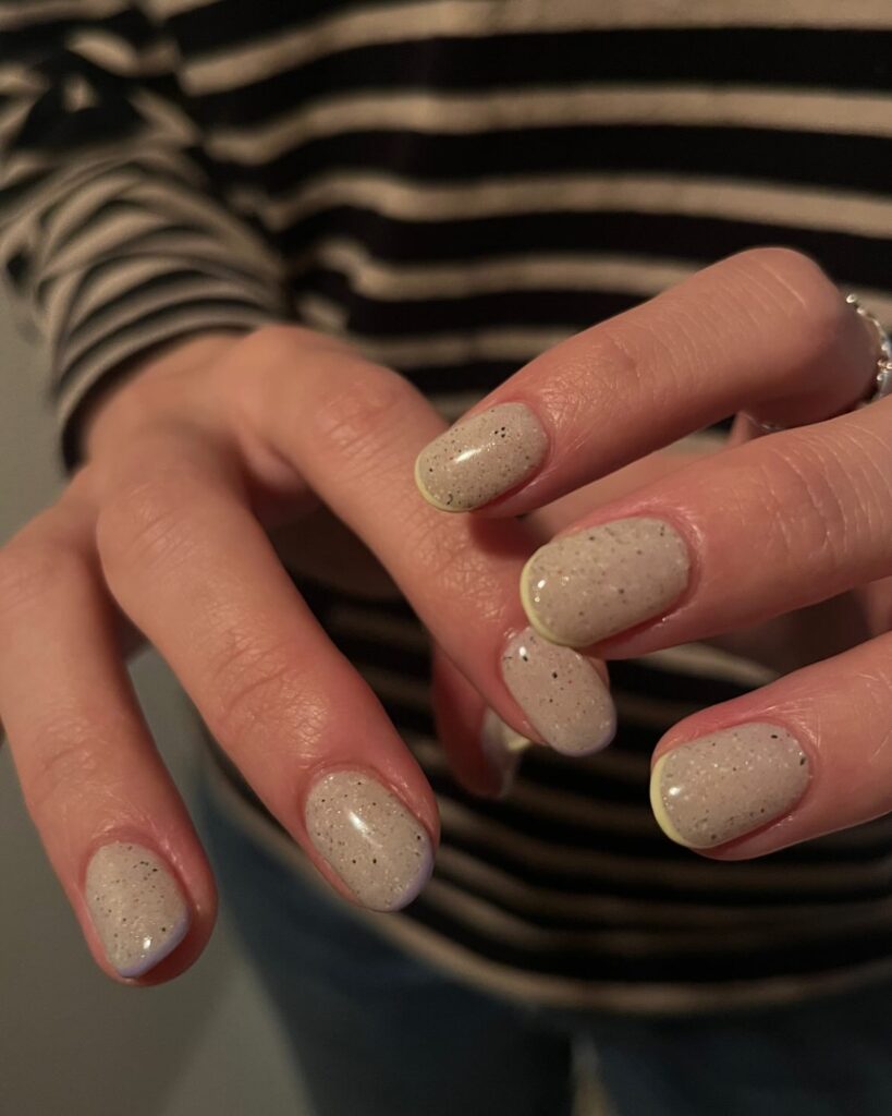 Neutral Beige Short Nails with Neon Yellow Tips and Black Speckles