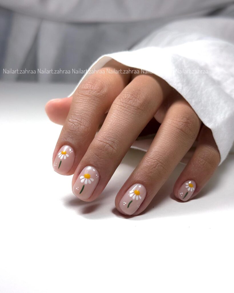 Nude pink daisy nails with white floral design soft spring nail ideas