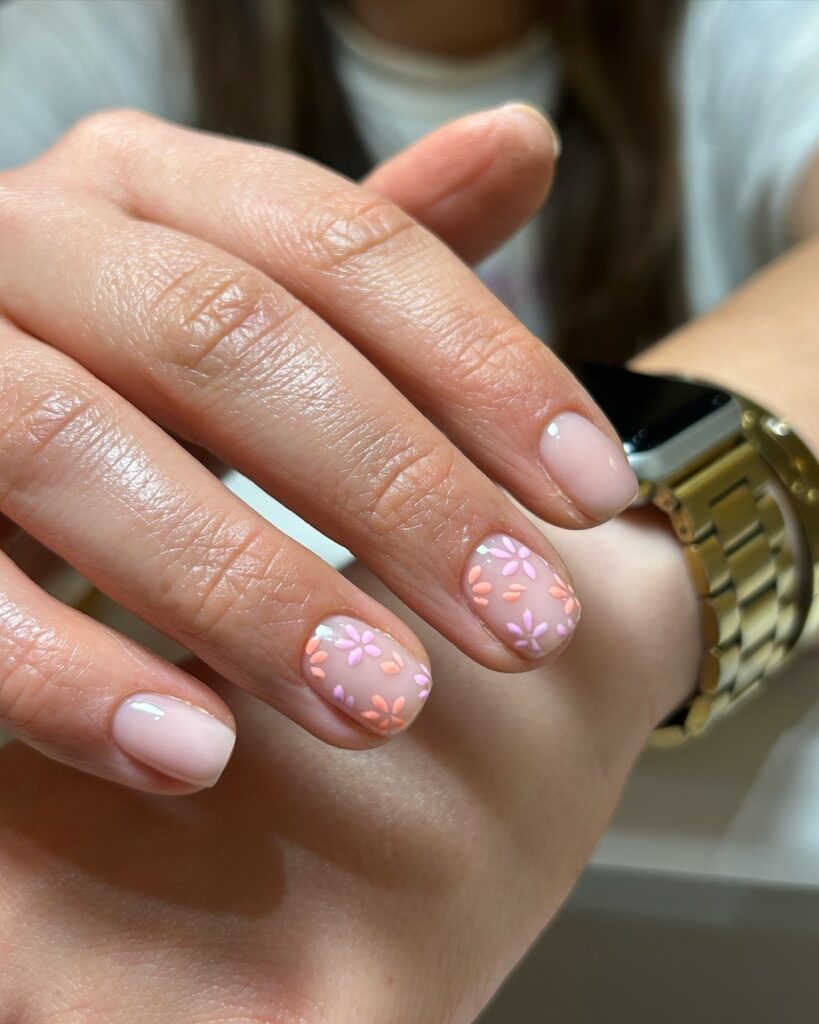 Nude pink nails with scattered pastel daisies subtle floral nail ideas for everyday style