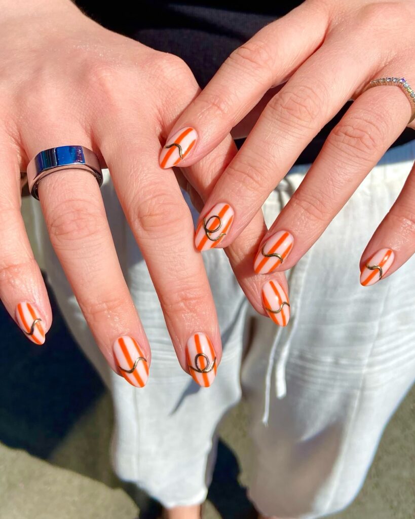 Orange and White Vertical Stripes with Gold Accents for Chic Short Almond Nails