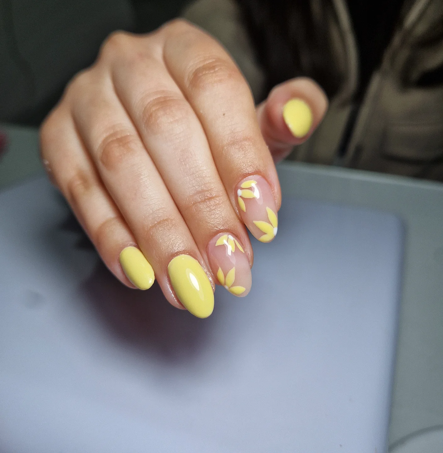Pastel Yellow Almond Nails with Delicate Floral Petal Art and Glossy Finish