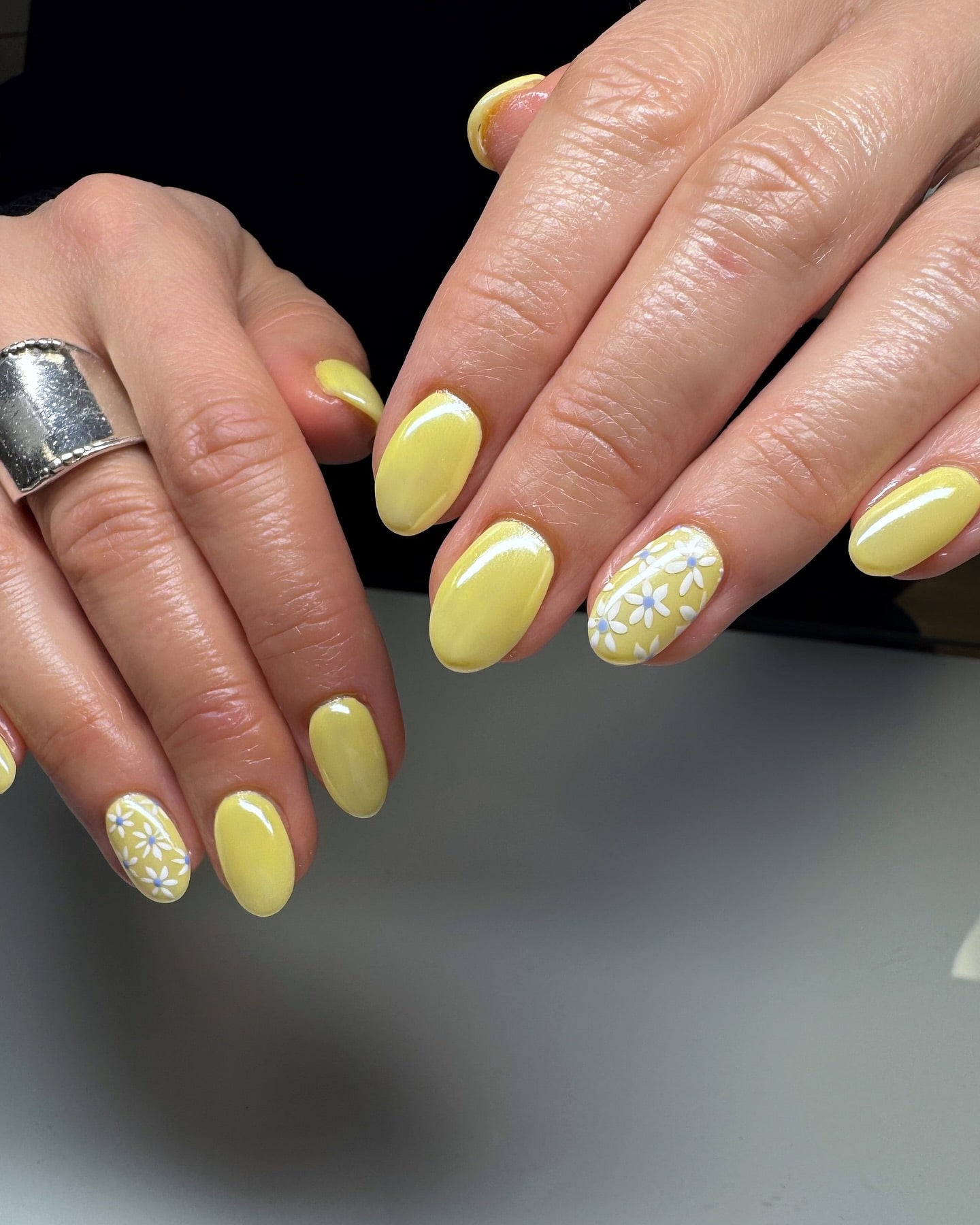 Pastel Yellow Nails with Glossy Finish and Delicate Daisy Floral Accents for Fresh Spring Nail Ideas