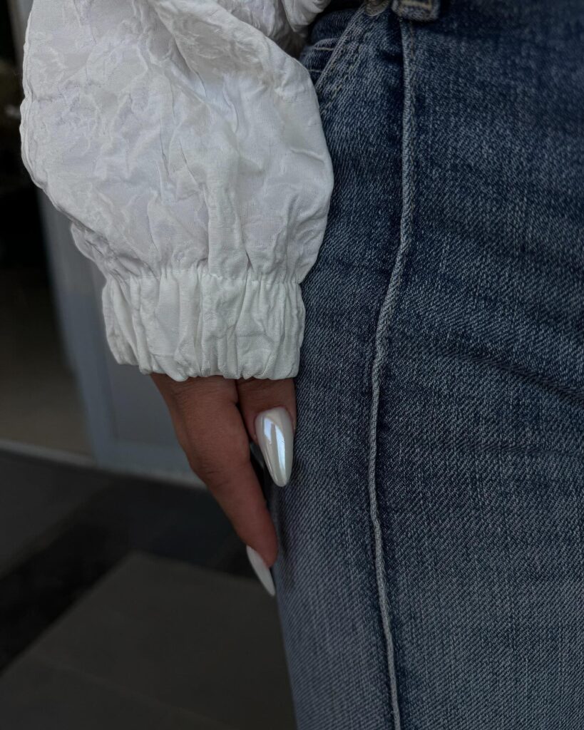 Pearly White Almond Nails with a Glossy Finish for a Glam Work Look