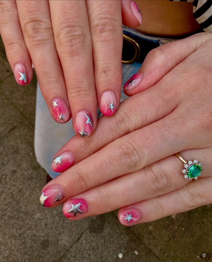 Pink-to-Nude Gradient Nails with Metallic Star Stickers for a Sparkly Summer Finish