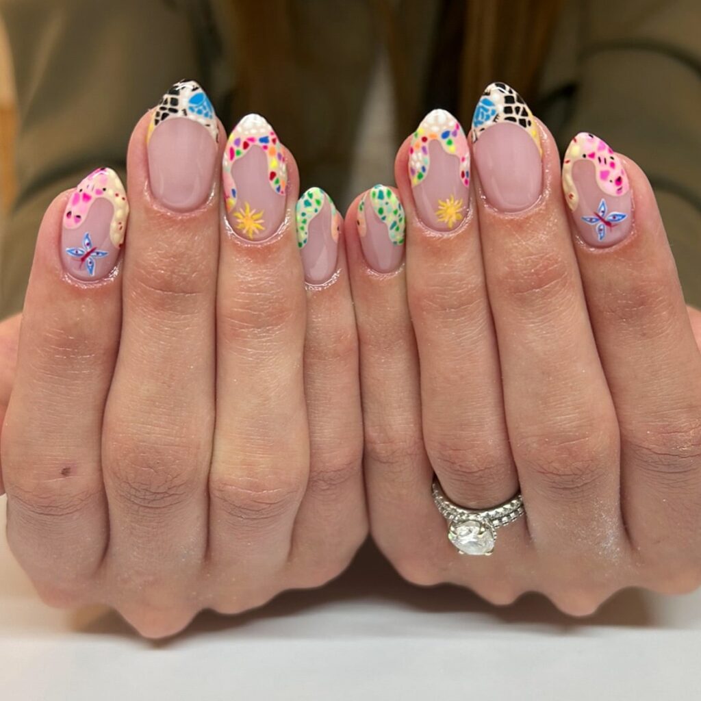 Rainbow French Tip Nail Art with Stars, Polka Dots, and Sheer Nude Base