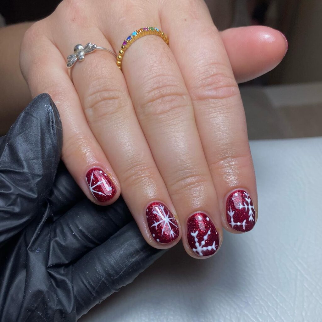 Short Glittery Red Holiday Nails with Snowflake and Winter Designs