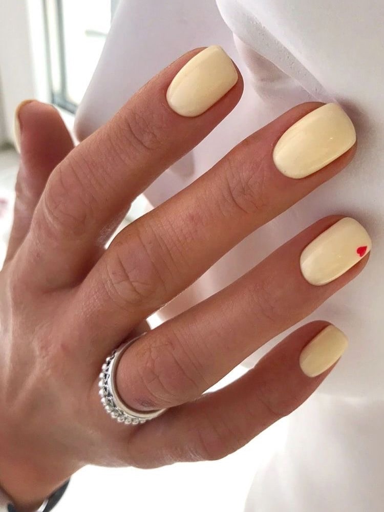Short Pastel Yellow Nails With Tiny Red Heart Accent for a Cute Everyday Look