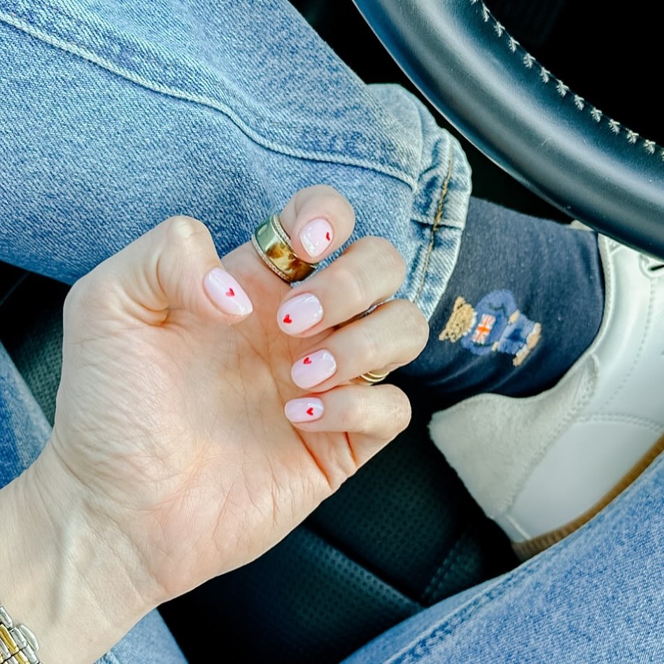 Short Round Pink Nails with Tiny Heart Accents for Subtle Romance