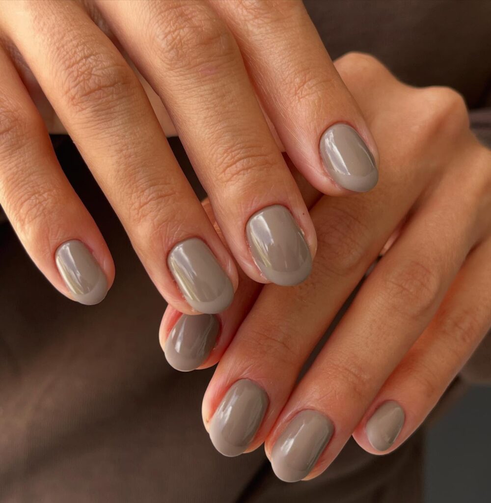 Stay polished with short rounded nails in muted taupe gray for a chic office style