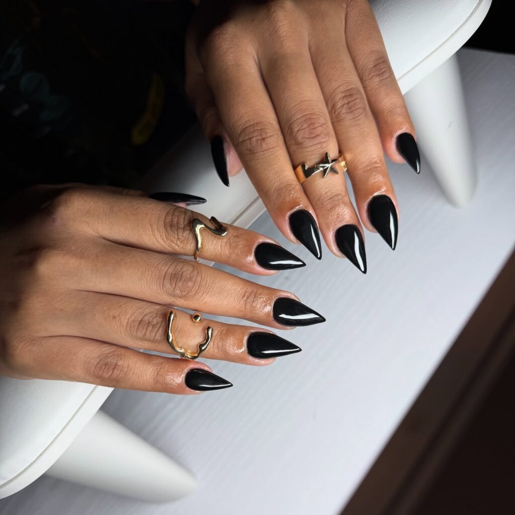 Stiletto black nails with mirror shine for a bold and edgy nail idea