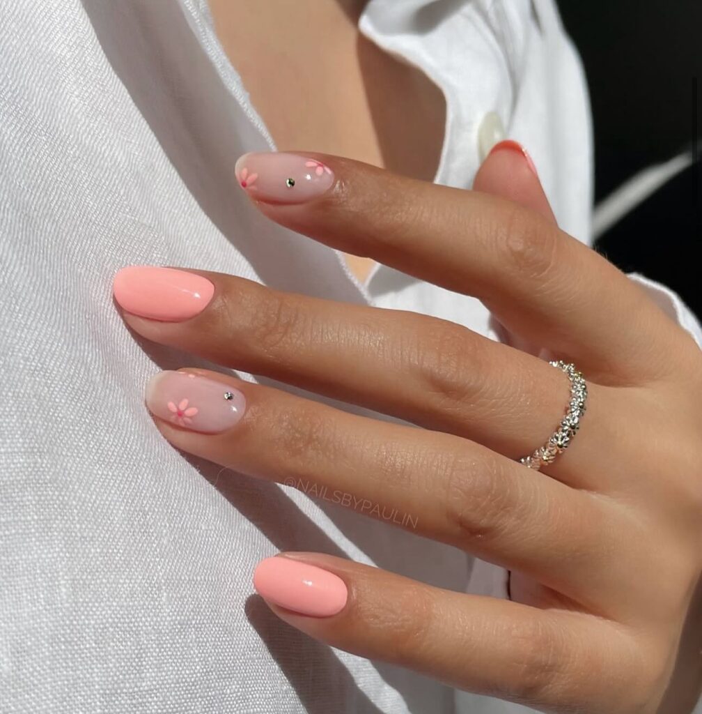 Try almond nails with peach and nude polish and daisy accents for a soft spring office look
