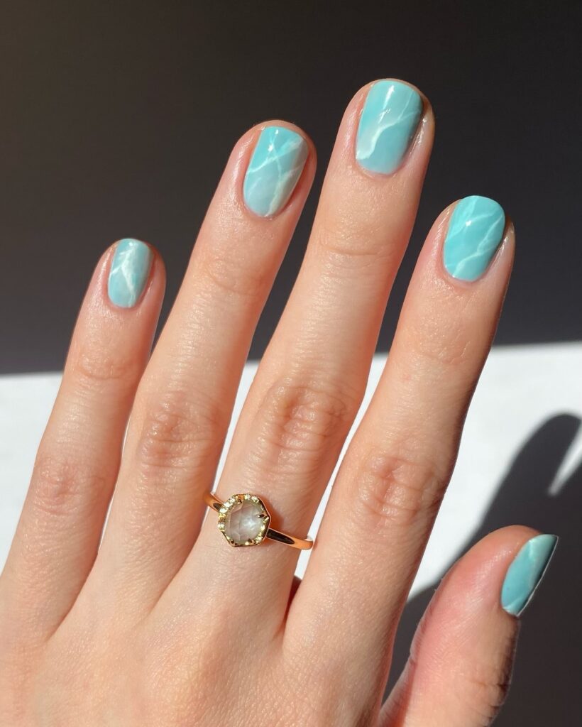 Turquoise marble nails with oval shape for dreamy beach nail ideas