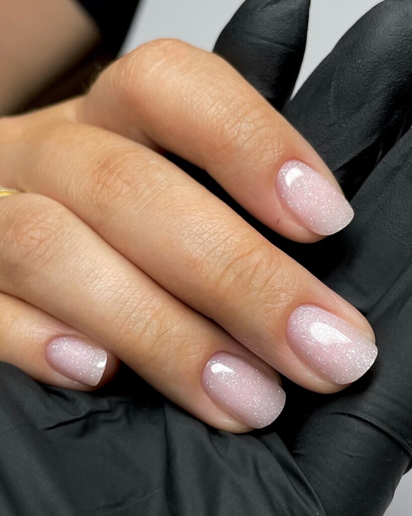 Wear squoval pink ombré nails with a subtle shimmer for a classy and professional style