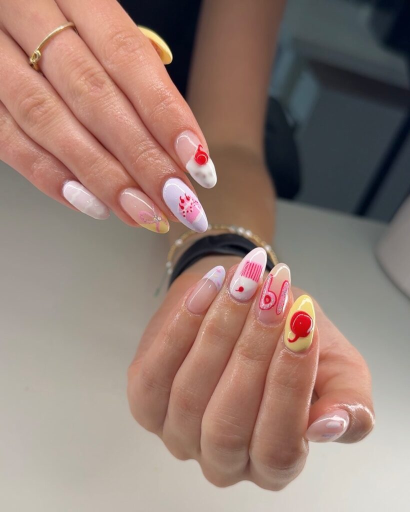 Whimsical Almond Birthday Nails with Hearts, Swirls, and Abstract Pink Artwork