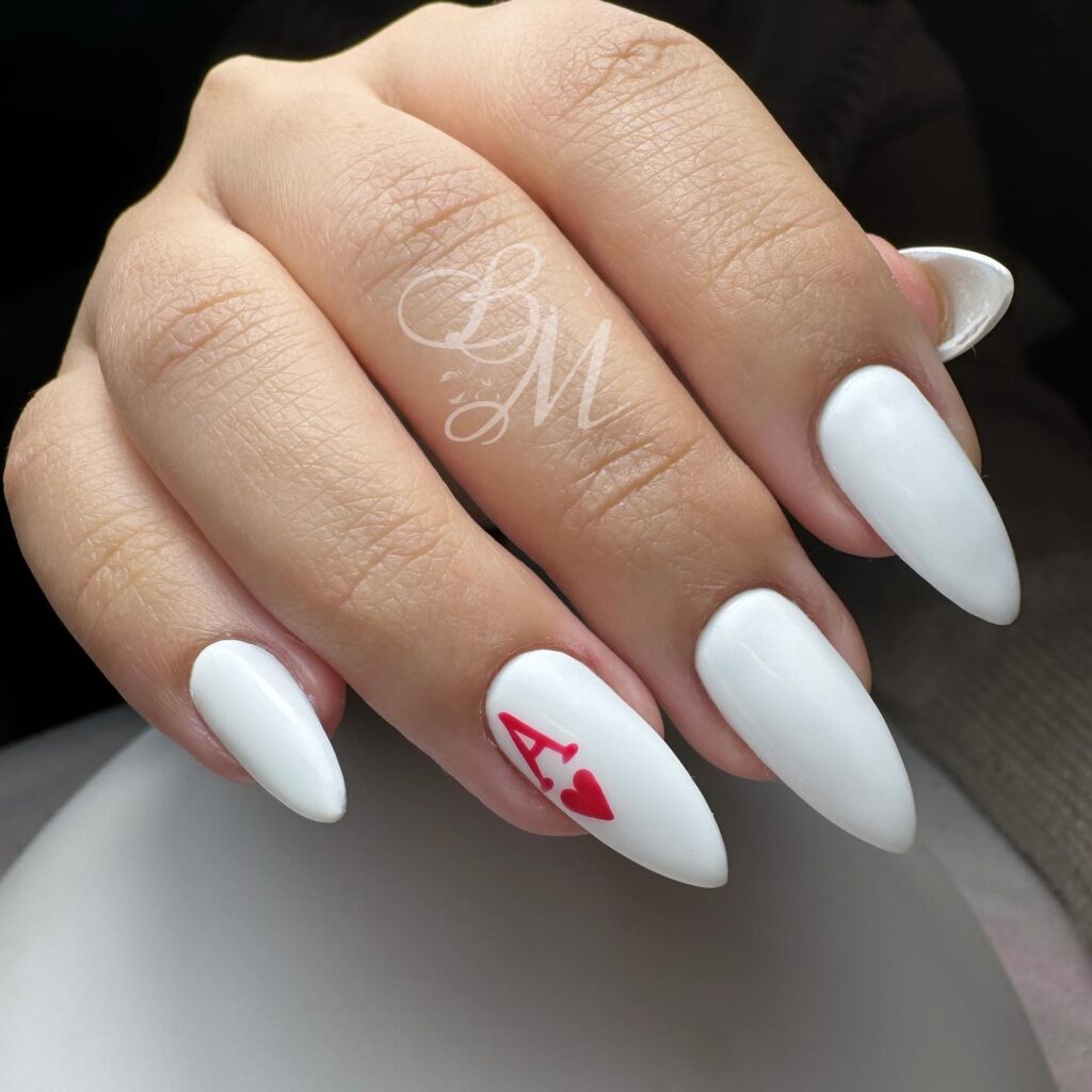 White Almond Nails with a Red Ace Accent for a Playful, Chic Twist